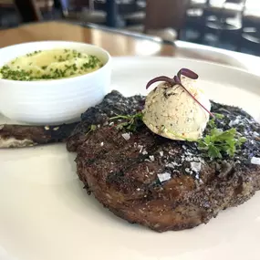 Bone-In Ribeye featuring a 16oz ribeye, Maitre d'Butter and truffle whipped Yukon potato.