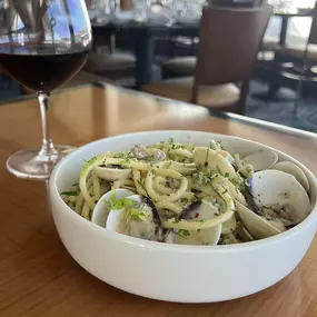 Clams Bucatini featuring Italian sausage, white wine, garlic, Grana Padano and parsley.