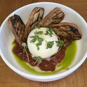 Mozzarella Di Burrata featuring cherry tomato jam, basil oil and grilled sourdough.