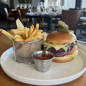 Short Rib Craft Burger served with grilled onion, romaine, tomato, bacon jam and gruyere on a brioche bun.