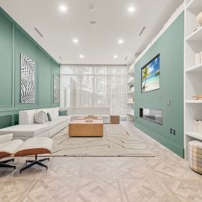 Library with Fireside Seating at The Marc Luxury Apartments in Palm Beach Gardens FL