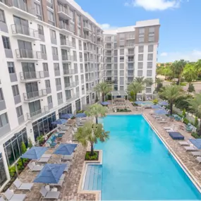 Pool Deck with Heated Pool, Lap Lane, Sun Loungers, and More at The Marc Luxury Apartments in Palm Beach Gardens FL