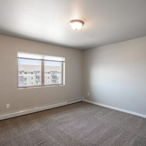 bedroom with carpet and a window