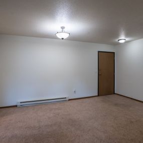 a dining room with a white wall and a door to a closet