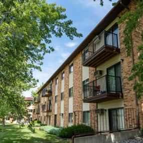 Exterior view of a brick apartment building with balconies