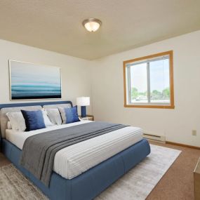 bedroom with a blue and white bed and a window