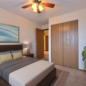 a bedroom with a bed and a ceiling fan