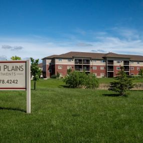 an urban plans sign in front of an apartment building