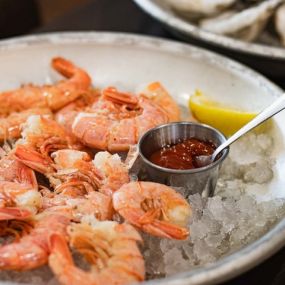 Shrimp served on ice and ready to eat with garish.