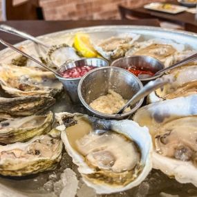 A dozen raw oysters on the half shell ready to eat.