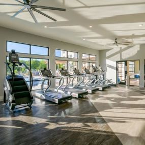 Gym with big windows and cardio equipment