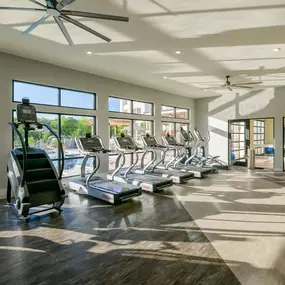 Gym with big windows and cardio equipment