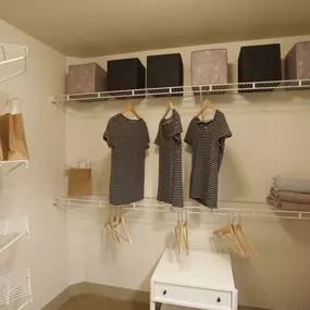 The bedroom at TwentyOne 01 on Market apartments includes a spacious walk-in closet.