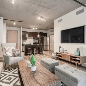 The living room at TwentyOne 01 on Market apartments opens to a spacious dining and kitchen area.