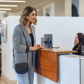 A customer at the service cashier desk