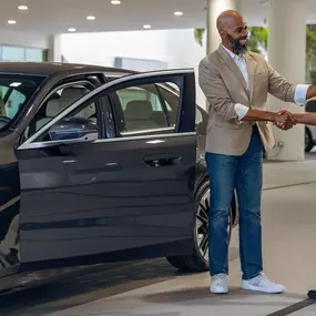 A service technician shaking hands with a customer