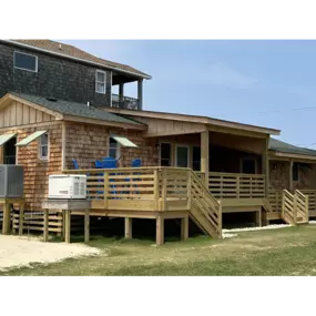 Custom home addition with Covered Porch, Natural Cedar Exterior, Handmade Juniper Shutters, and new Master Suite