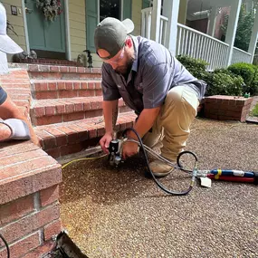 Revitalizing your home's foundation with precision! Watch our expert team at American Standard Foundation Repair in action as they perform a concrete lifting service, ensuring stability and safety for your property!