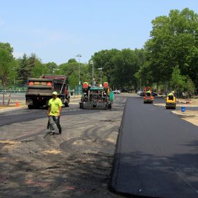 Smooth paving workers completing a asphalt pavement project.