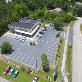 Aerial view of a auto shop parking lot that has been freshly redone.