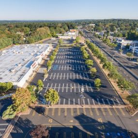 Aerial view of a parking lot that has fresh asphalt and line striping.