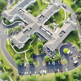 Aerial view of a business center with fresh asphalt pavement in their parking lot.