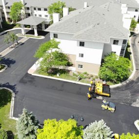 Housing complex with asphalt paving resurfacing in progress.