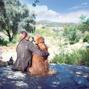 A woman and her dog enjoying the view.