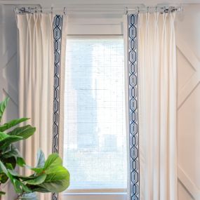 We love this simple white linen drape with navy tape & you can never go wrong with acrylic hardware.