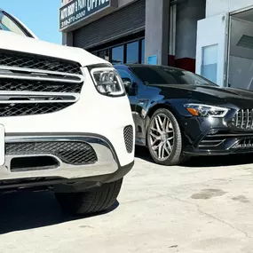 Mercedes Benz White SUV and Black Sedan parked at LUXE Auto Body Shop