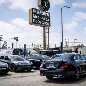 Detailed photo of Mercedes waiting at auto body shop parking lot for collision repair