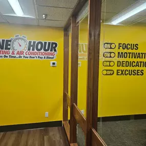 One Hour Heating & Air Conditioning offices with Logo on a yellow wall