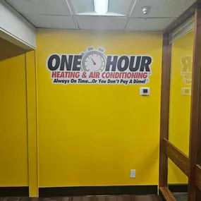 One Hour Heating & Air Conditioning offices with Logo on a yellow wall