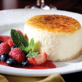 The Capital Grille Cheesecake brûléed to order by our in-house pastry chef and served with fresh berries.