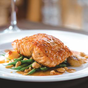 Seared Salmon featuring our housemade citrus glaze, French green beans with brown butter and Marcona almonds.
