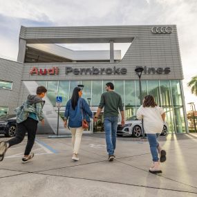 Family walking towards the entrance of Audi Pembroke Pines