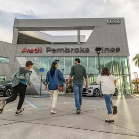 Family walking towards the entrance of Audi Pembroke Pines