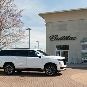 White Cadillac Escalade in front of Holman Cadillac entrance