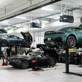 Vehicles up on lifts in a Holman Motorcars' service center