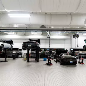 Vehicles up on lifts in a Holman Motorcars' service center