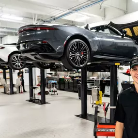 Vehicles up on lifts in a Holman Motorcars' service center