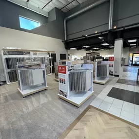 This image showcases the interior of the Focal Point Flooring showroom. The space is open and airy, with high ceilings and large windows.