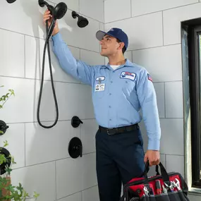 Roto-Rooter Plumber repairing shower