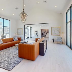 Resident lounge with orange furniture and large windows