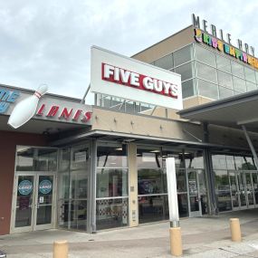 Exterior photograph of the Five Guys restaurant at 3850 Merle Hay Mall Road in Des Moines, Iowa.