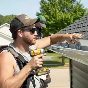 Larson & Keeney Contractor Installing a New Gutter System