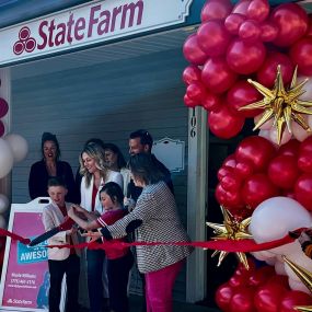 Nicole and her family cutting the ribbon on opening day.