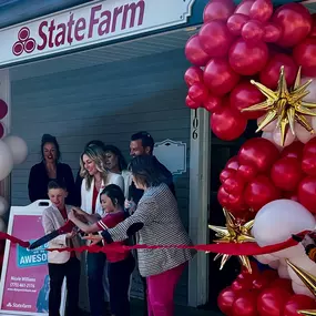 Nicole and her family cutting the ribbon on opening day.