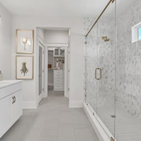 Luxurious primary bathrooms with expansive walk-in closets