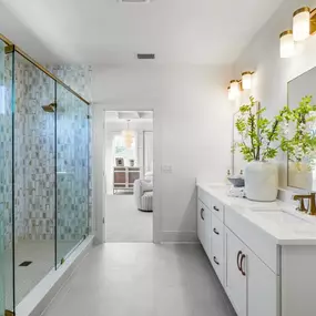 Luxurious primary bathrooms with expansive walk-in closets